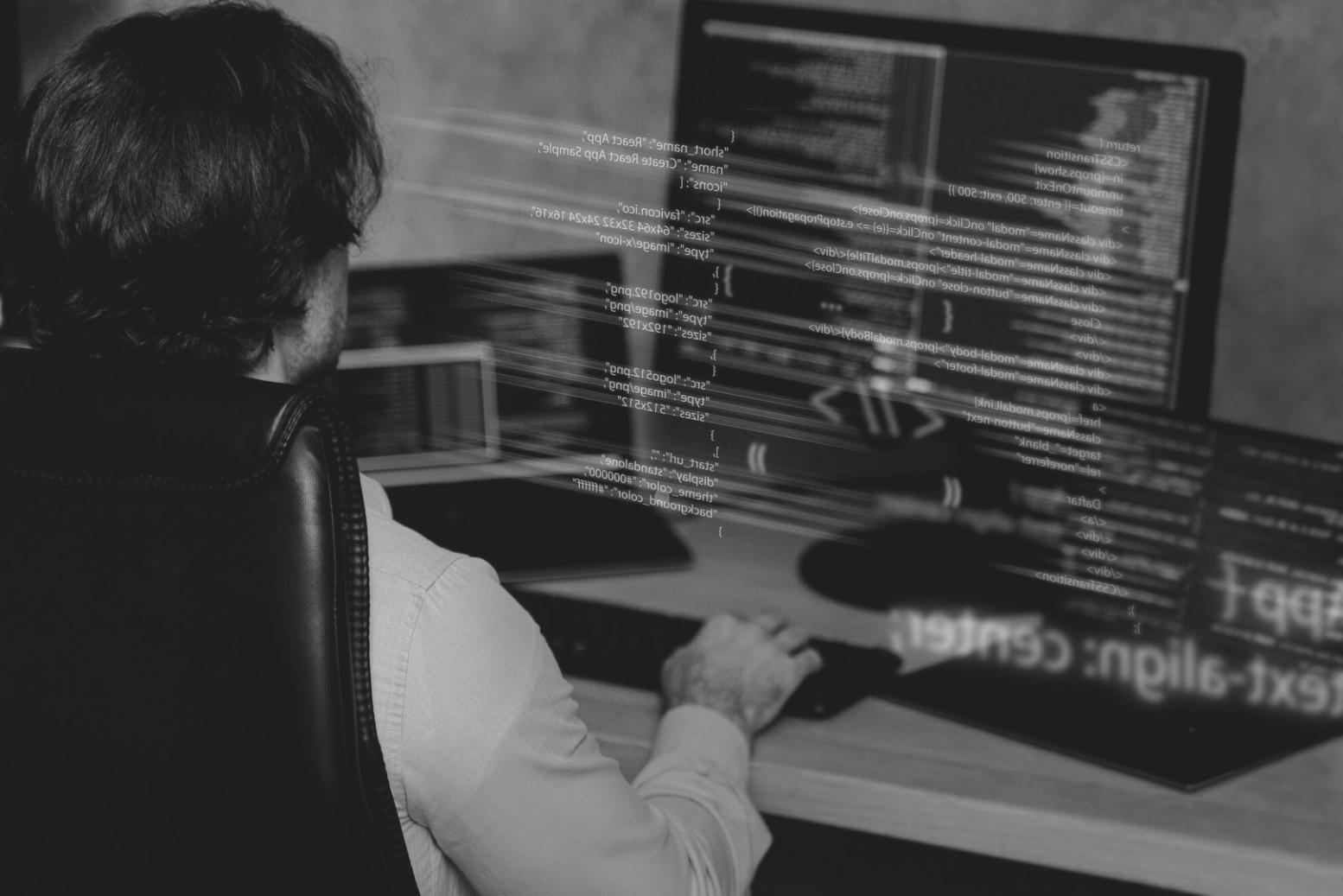 Developer reviewing Python mobile game code on a laptop